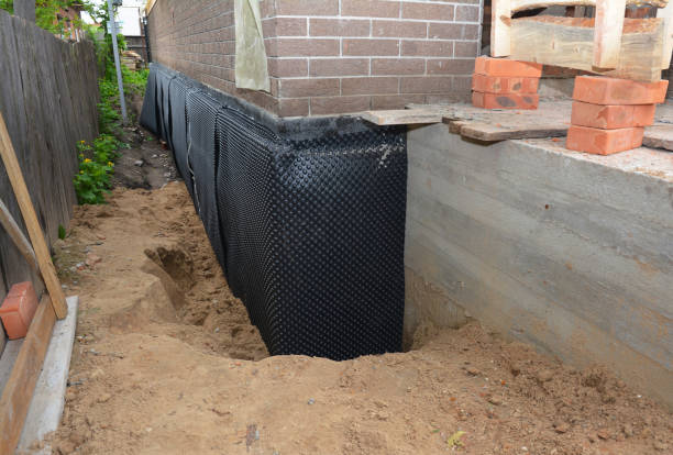 Happy homeowners after waterproofing job in Coats